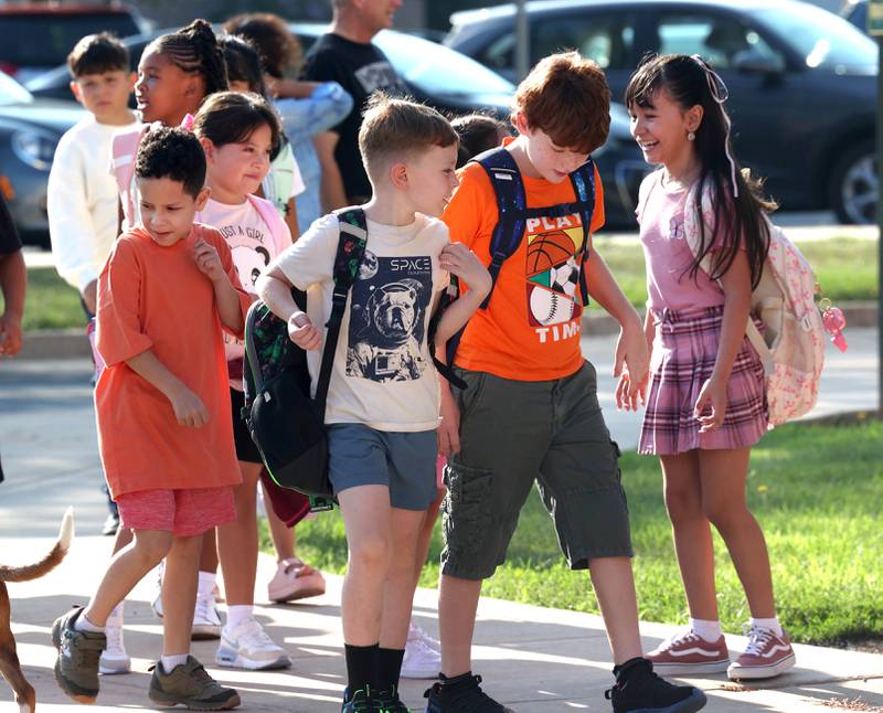 Students arrive for the first day of school Wednesday, Aug. 13, 2025, at Founders Elementary in DeKalb.