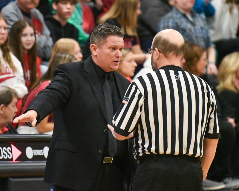 Yorkville Christian's head coach Aaron Sovern talks with an official after an incident with a fan and receiving a technical earlier in the game on Friday Feb. 28, 2025, while taking on Aurora Christian in the regional title game held at Indian Creek High School.