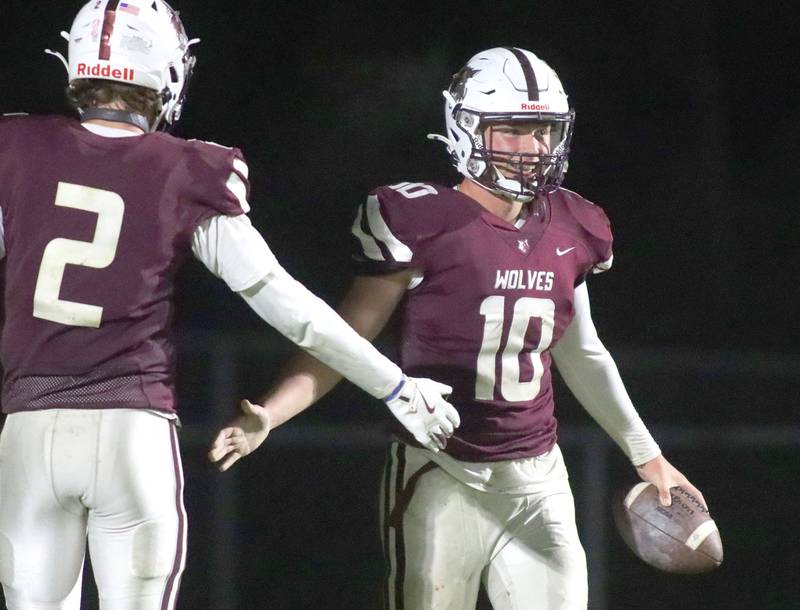 Prairie Ridge’s Owen Satterlee, right, is greeted in the end zone after scoring on a reception against Vernon Hills in IHSA football Class 5A first-round playoff action at Prairie Ridge High School in Crystal Lake on Friday, October 31, 2025.