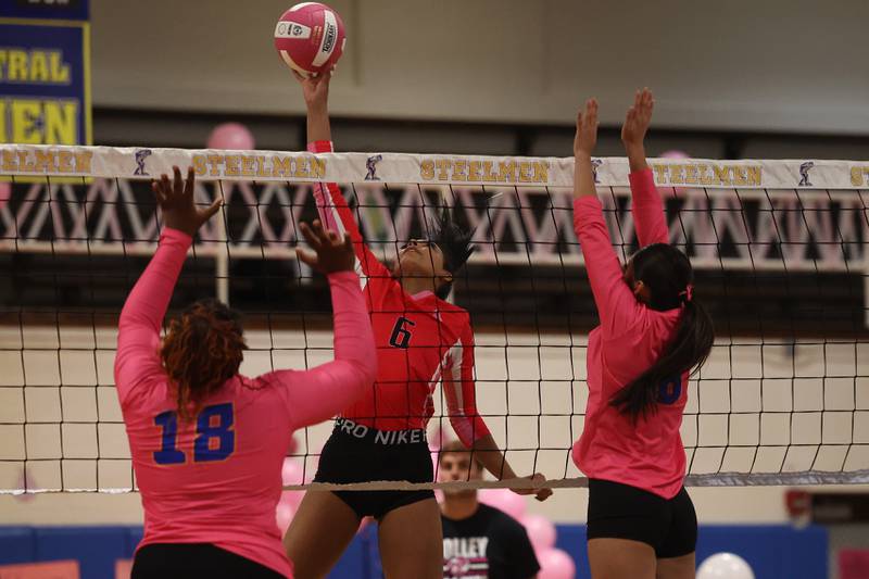 Joliet West’s Faith Jordan stretches for the ball against Joliet Central in the annual Pink Heals cancer fundraising match on Thursday, Oct. 17, 2024 in Joliet.