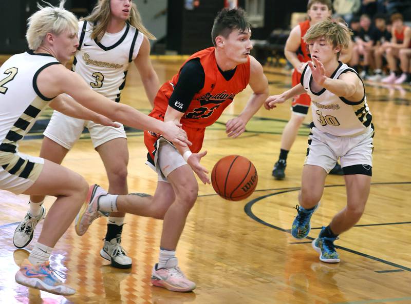Sandwich's Chance Lange splits two Sycamore defenders during their game Friday, Nov. 24, 2023, in the Leland G. Strombom Holiday Tournament at Sycamore High School.