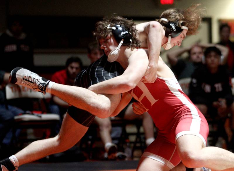 Crystal Lake Central’s Owen Battaglia, left, battles Huntley’s Lucas Bittman in a 175-pound bout in varsity wrestling at Crystal Lake Friday.  Bittman won the match.