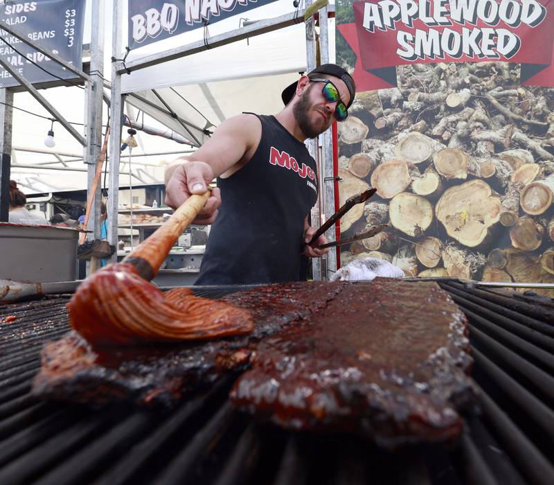 Mojos Famous BBQ, Grill Master, Guy Wilkinson puts some sauce on the ribs during Lake in the Hills RockinÕ Rotary Ribfest Saturday, July 12, 2025 in Lake in the Hills.