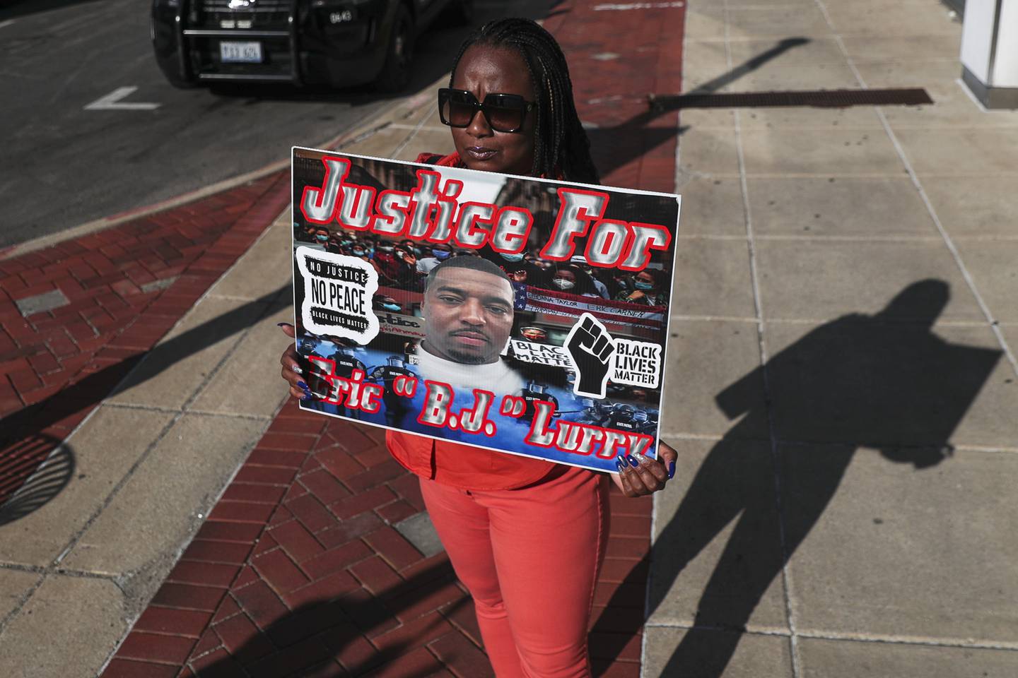 Nicole Lurry holds a sign calling for further investigation into the death of her husband Eric Lurry, a Joliet resident who died while in police custody, on Friday, Sept. 17, 2021, outside of the District Attorney's Office in Joliet, Ill.