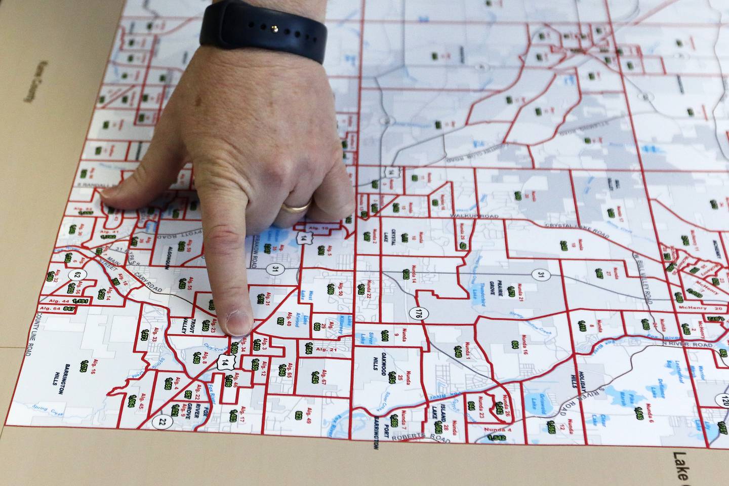 McHenry County board member Joe Gottemoller shows a current map of McHenry County voter districts and precincts on Friday, April 30, 2021 in Crystal Lake. The county is considering redistricting and is awaiting updated census information.