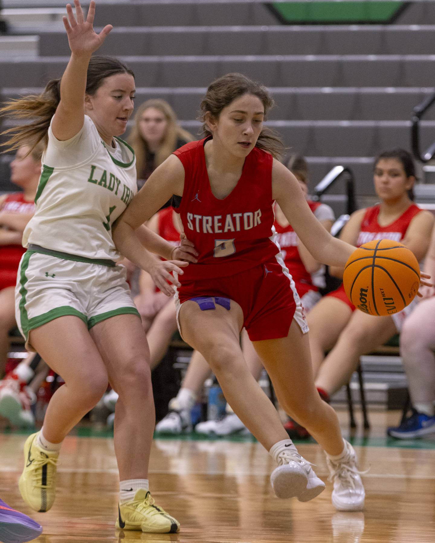 Audrey Arambula of Streator High School drives the ball to the basket against against a Seneca High School athlete during the Falcon-Irish Girls Basketball Tournament on November 19, 2024 at Seneca High School.