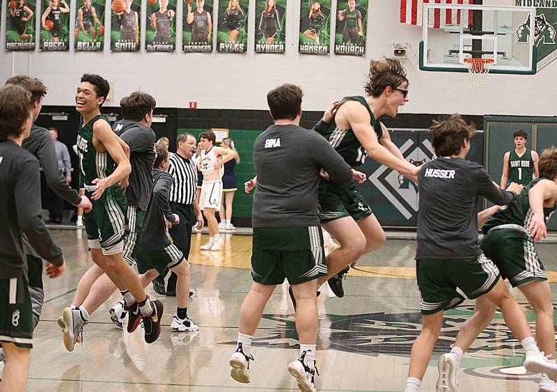 Members of the St. Bede boys basketball team react after getting an upset victory over number one seed Marquette in the Class 1A Regional semifinal on Wednesday, Feb. 22, 2023 at Midland High School.