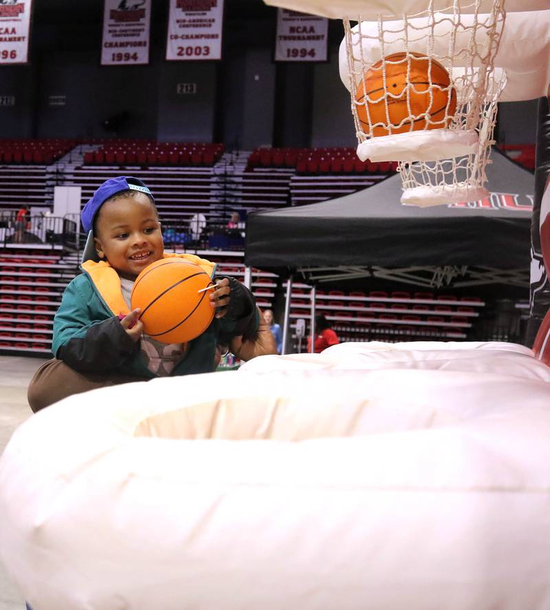 Sovereign Sanders, 4, from DeKalb, gets a boot from his mom to make a basket in the Kids Camp Thursday, April 24, 2025, during the Local Showcase and Spring Show in the Convocation Center at Northern Illinois University in DeKalb.