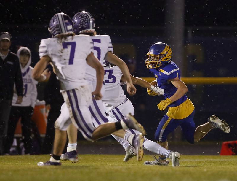Johnsburg's Jake Metze tries to turn the corner as he rushes during a IHSA Class 4A second round playoff football game Friday, Nov. 4, 2022, between Johnsburg and Rochelle at Johnsburg High School in Johnsburg.