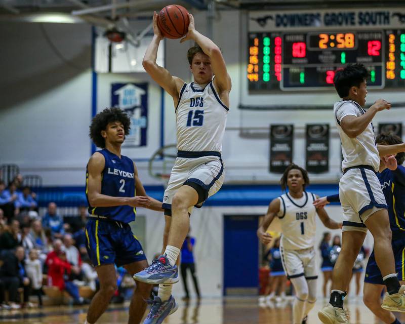 Downers Grove South's Daniel Laurich (15) grabs a rebound during basketball game between Leyden at Downers Grove South. Feb 9, 2024.