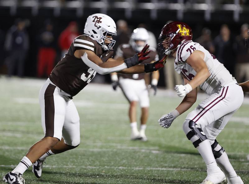 Mt. Carmel's Braeden Jones (99) rushes the Loyola offense during the varsity football game between Loyola Academy and Mt. Carmel high school on Friday, Oct. 25, 2024 in Chicago.