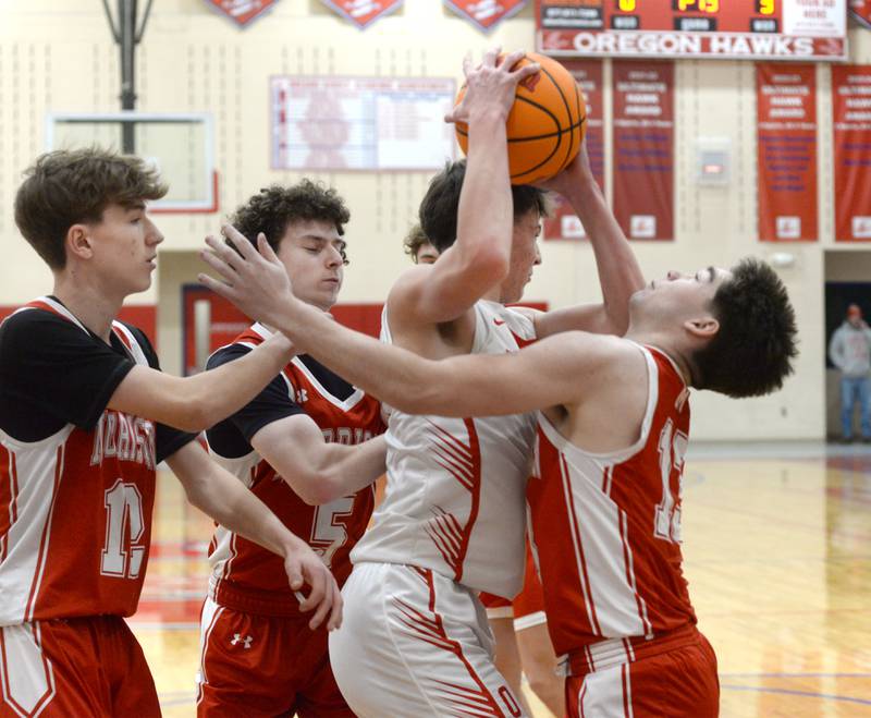 Oregon's Jackson Caposey (4) draws Morrison defenders Kolton Swaim, Brayden Rubright, and Jeremiah Callan on Saturday, Jan. 11, 2025 at the Blackhawk Center in Oregon.