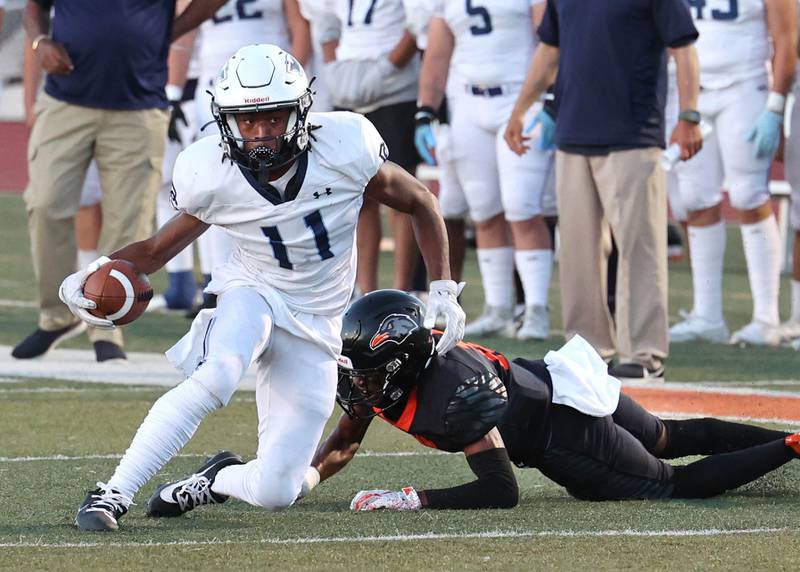 Plainfield South's Andreas Amos II breaks a DeKalb tackle after a catch during their game Friday, Sept. 1, 2023, at DeKalb High School.