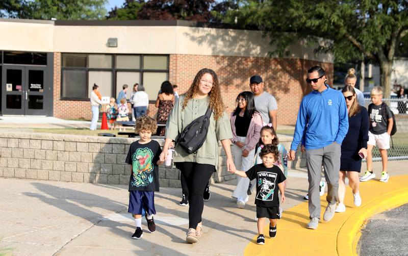 Students and parents arrive on the first day of school Thursday, Aug. 22, 2024 at Harrison Street Elementary School in Geneva.