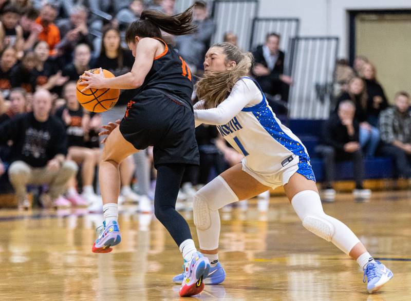 Wheaton North’s Adeline Sutton guards Wheaton Warrenville South’s Emily Troia during a game at Wheaton North High School on Friday, Dec. 20, 2024.