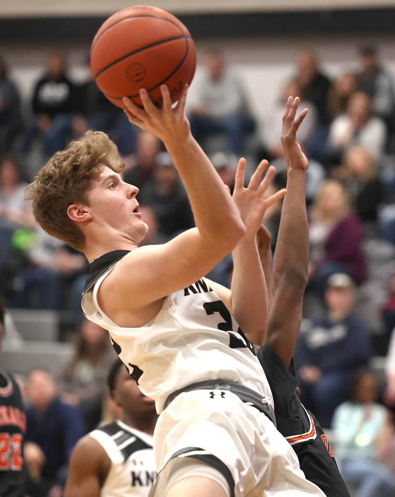 Kaneland's Johnny Spallasso gets to the basket ahead of DeKalb's Johnny Henderson during their game Tuesday, Jan. 24, 2023, at Kaneland High School.