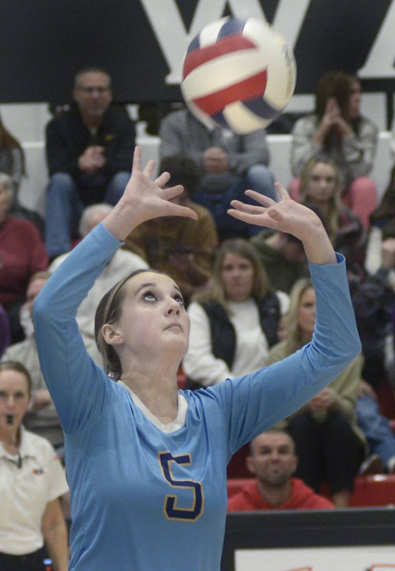 Marquette’s Kealy Rick works to keep the ball in play the 2nd set Tuesday against Lexington at the Woodland Sectional.