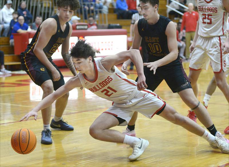 Streator’s Brennen Stillwell dives ahead of East Peoria’s Quinton Kitt and Mason Isaacs to keep the ball in bounds in the 1st period Wednesday at Streator.