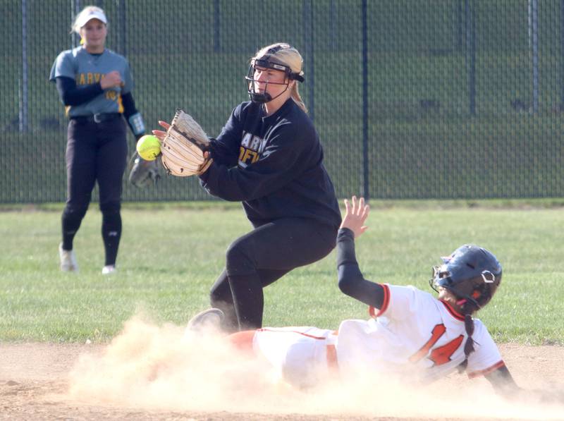 Crystal Lake Central’s Lily Perocho slides safely into second base as Harvard’s Manahtyn Brincks handles the throw in varsity softball at Crystal Lake Central High School in Crystal Lake on Monday, May 19, 2025.