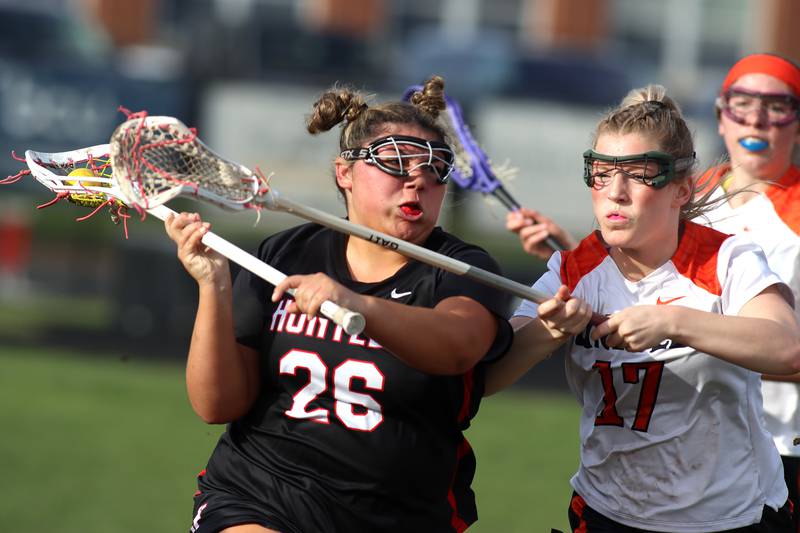 Crystal Lake co-op’s  Ella Trudeau, right, guards Huntley’s Payton Turk in varsity girls lacrosse on Friday, April 18, 2025, at Metcalf Field on the campus of Crystal Lake Central High School in Crystal Lake.
