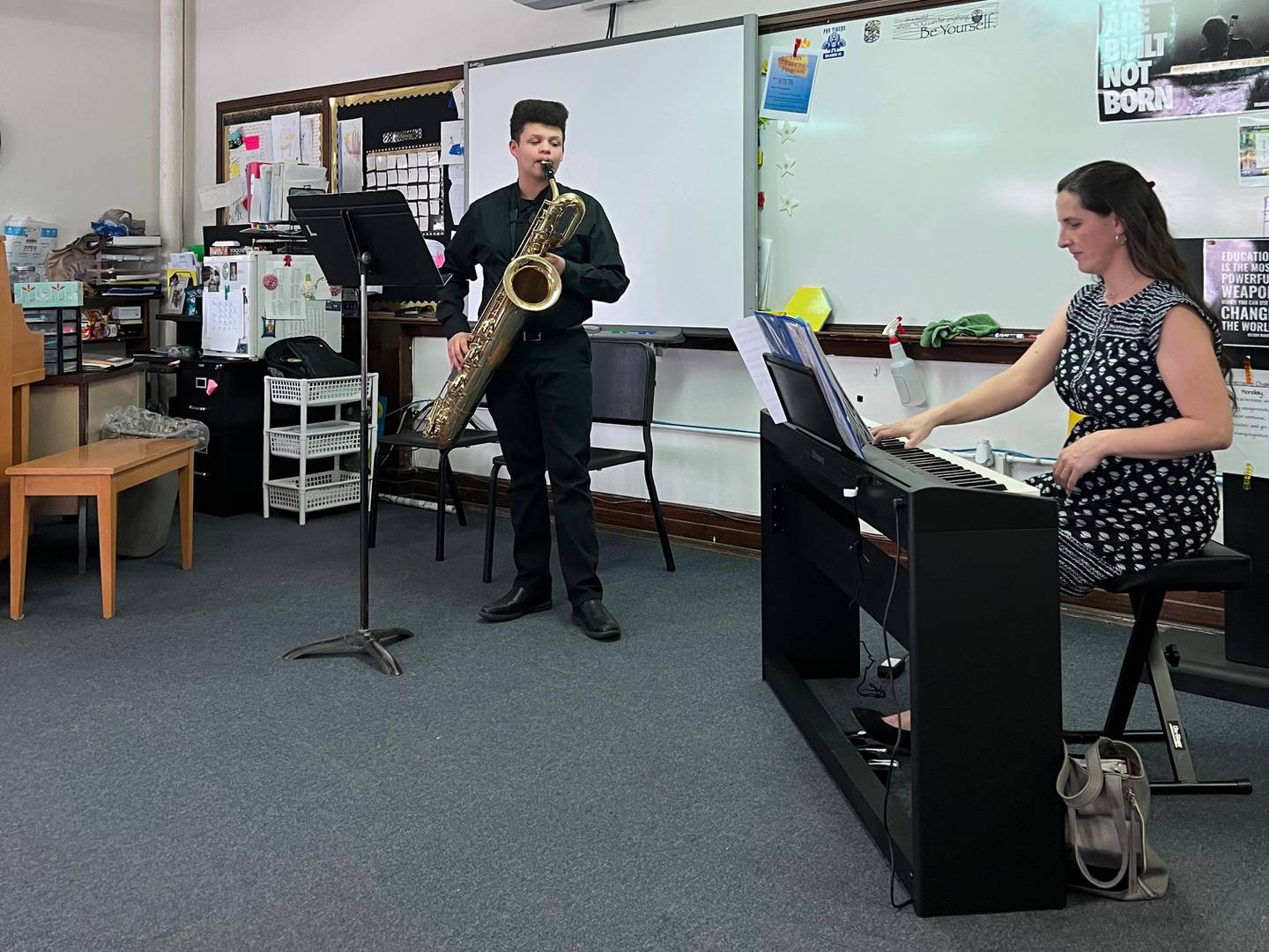 Levi Boggs plays a saxophone solo, accompanied by Christina Batchelor accompanying on piano.