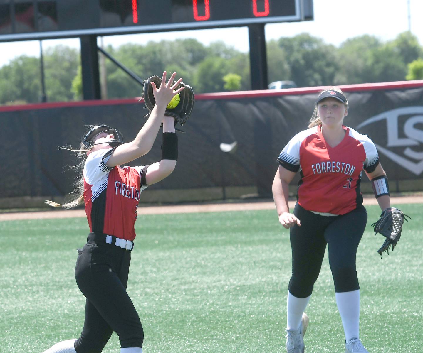 Forreston second baseman Alaina Miller catches a fly ball as right fielder Aubrey Sanders watches during action against Casey-Westfield in the 1A semifinal game on Friday, June 3 in Peoria.