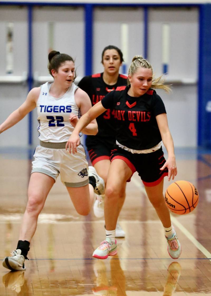 Hall's Charlie Pellegrini brings the ball upcourt against Princeton's Camryn Driscoll in Thursday's game at Prouty Gym. The Tigresses won 34-30.