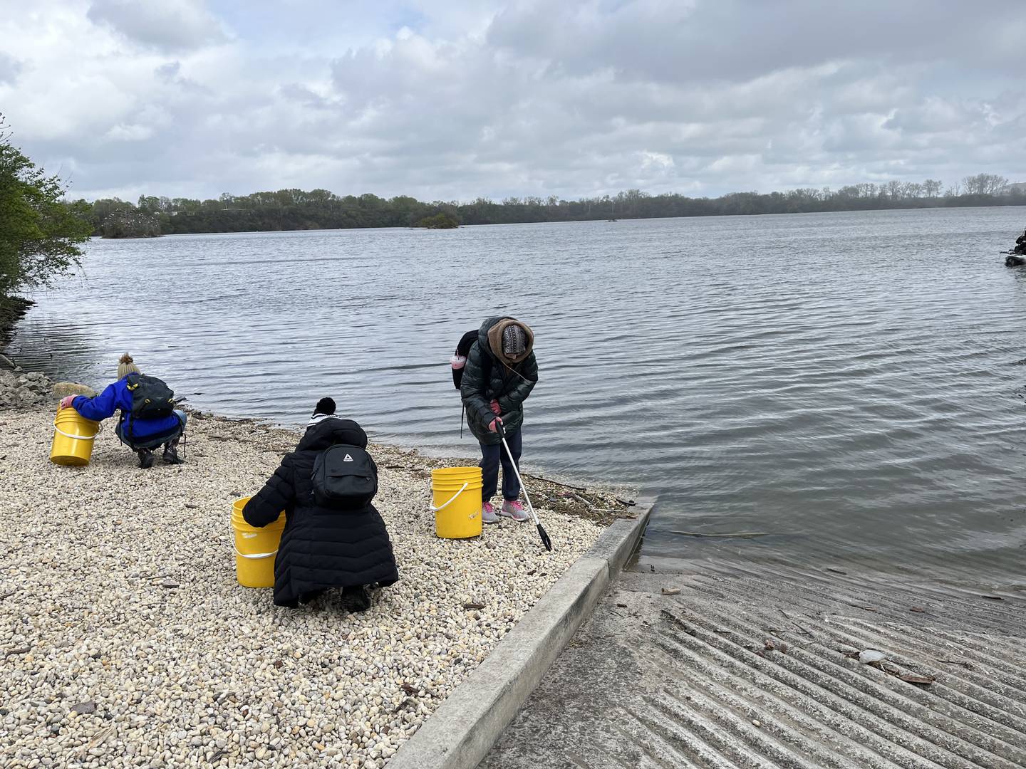Volunteers help clean up plastic trash and other litter on Saturday at the Rock Run Rookery Preserve in Joliet. The cleanup was hosted by the Forest Preserve District of Will County in recognition of Earth Day.