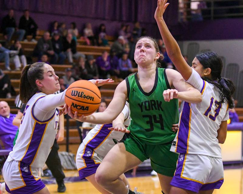 York's Olivia Silkaitis, second from right gets her shot blocked by Downers Grove North's Lauren Olson, second from left, and defended by Downers Grove defenders Adysen Fanta, left, and Urja Shah (13), right, on Tuesday Dec. 3, 2024, held at Downers Grove North.