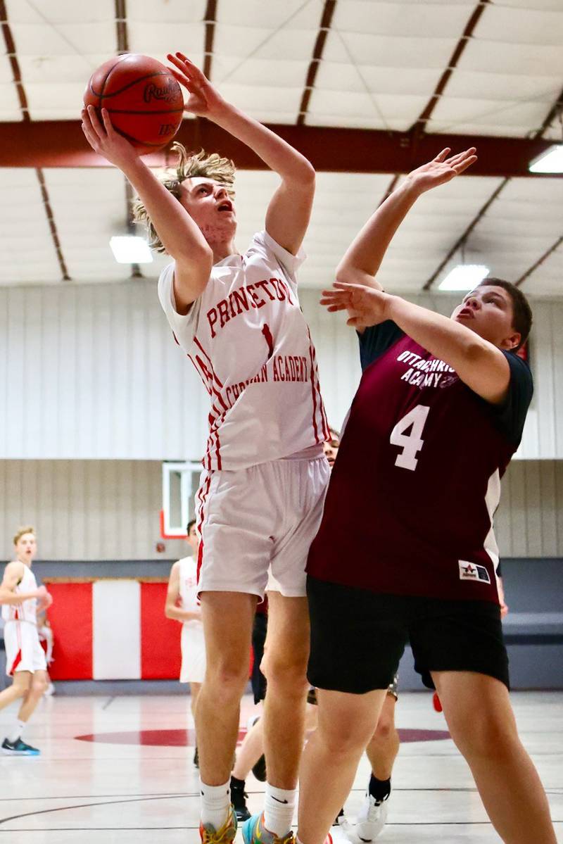 Princeton Christian Academy's Julian Mucha shoots over Ottawa Christian Academy's Ashton Gonzalez in Tuesday's game at Howard Hoffman Memorial Gym. The Eagles won 57-42.