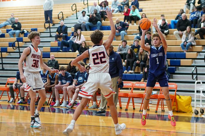 Plainfield South's Jeremiah Huerta (1) shoots a three pointer against Oswego’s Luke Roller (22) during a basketball game at Oswego High School on Friday, January 17, 2025.