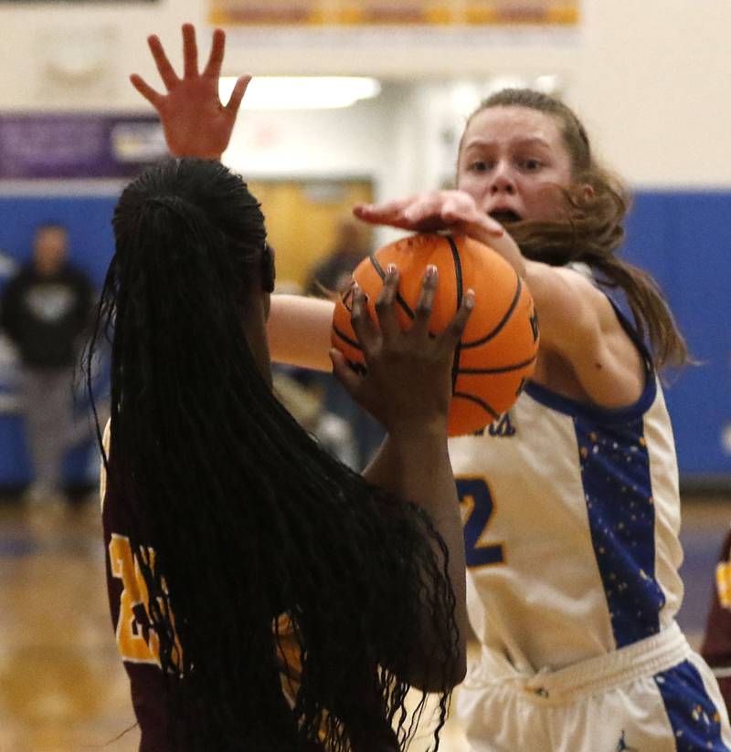 Johnsburg's Skye Toussaint tries to take the ball from Chicago Marshall's Chamarre Scott during a IHSA Class 2A Johnsburg Sectional girls basketball semifinal game on Tuesday, February, 24, 2026, at Johnsburg High School.