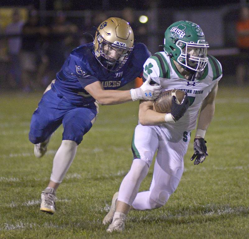 Seneca’s Wyatt Tiffany breaks away from a tackle by Marquette’s Easton Debernardi in the 2nd quarter Friday at Marquette.