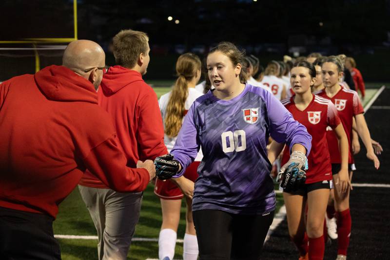 Kristen Hoenert (00) of Metamora fist bumps Kevin Olesen of Ottawa after win on Tuesday, May 21, 2025 at Malone Field in Metamora.