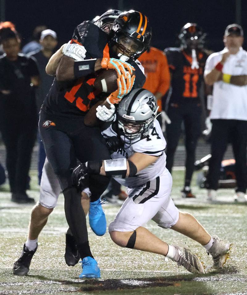 DeKalb's Davon Grant is brought down by Kaneland's Rogan O'Neil during their game Friday, Sept. 12, 2025, at DeKalb High School.