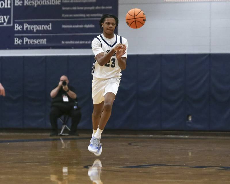 Oswego East's Mason Lockett (23) passes the ball down court during their basketball game between Yorkville at Oswego East. Friday, Dec 19, 2025 in Oswego.