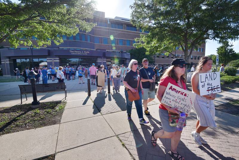 People leave a rally in support of women’s rights at the Henry J. Hyde Judicial Office Facility in Wheaton and march to an early voting location on Friday, June 24, 2022.