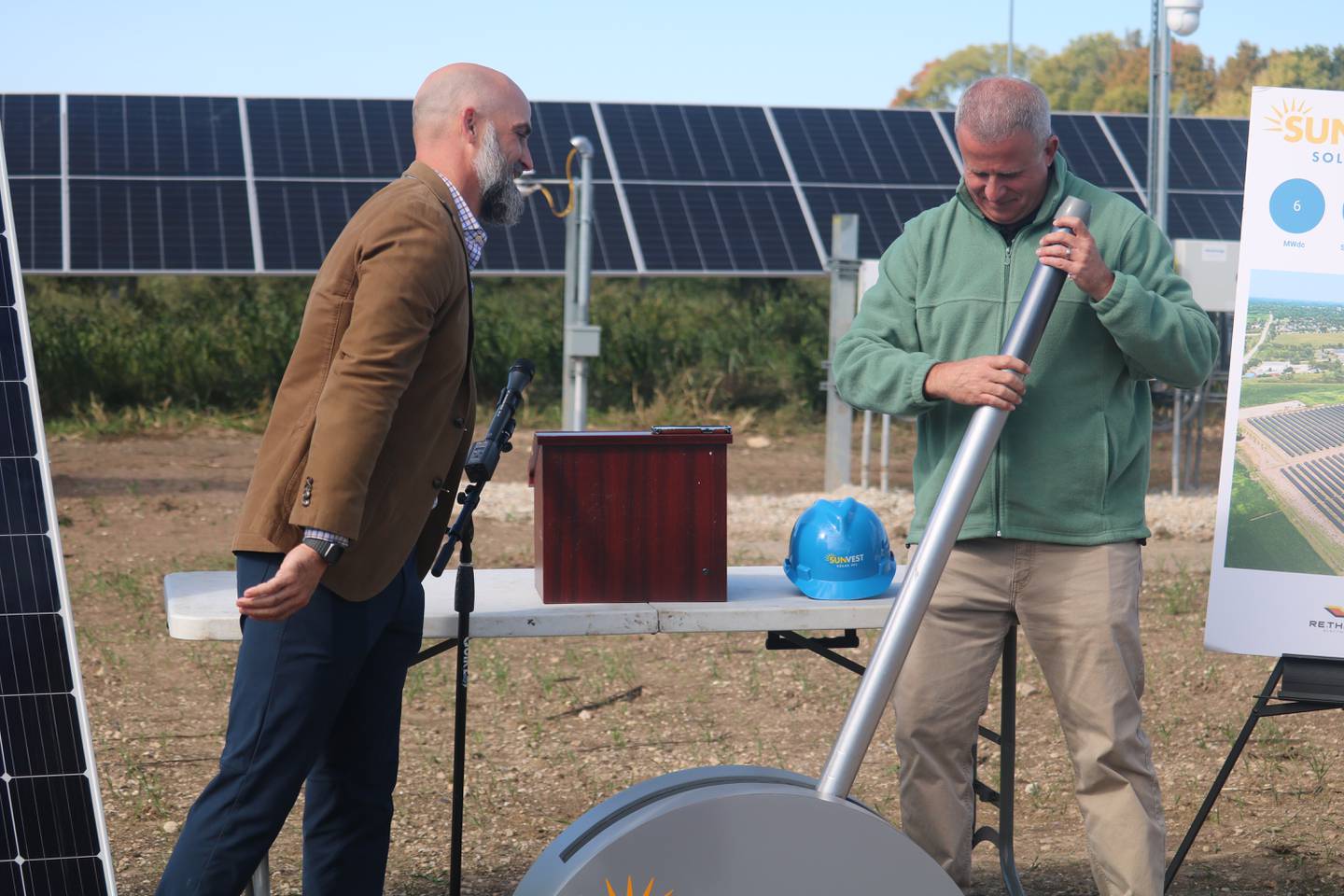 Tim Polz (left) and DeKalb Mayor Cohen  Barnes ceremoniously flips the switch at a ceremony held Oct. 10, 2023 in DeKalb to celebrate the activation of two community solar installation projects.