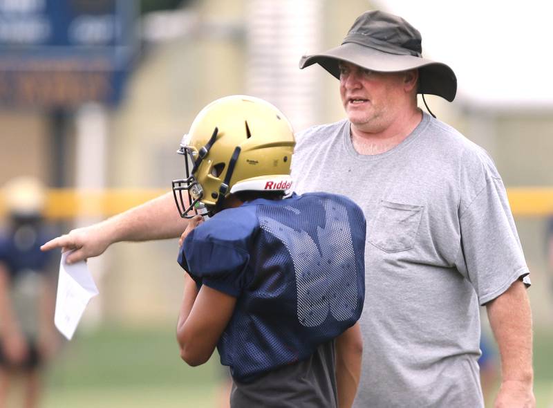 New Hiawatha head football coach Kenny McPeek talks to a player during practice Wednesday, August 9, 2023, at the school in Kirkland.