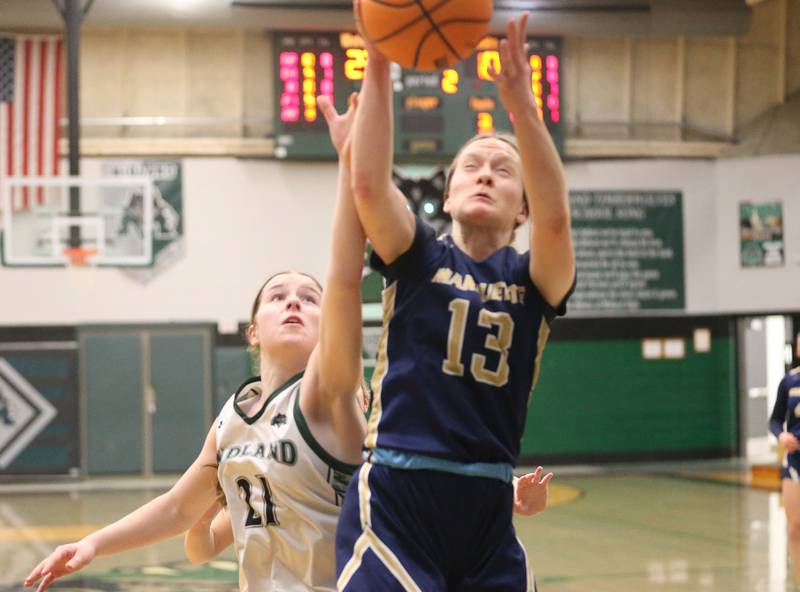 Marquette's Emily Ryan-Adair grabs a rebound over Midland's Adalynn Stickle on Thursday, Feb. 12, 2026 at Midland High School.