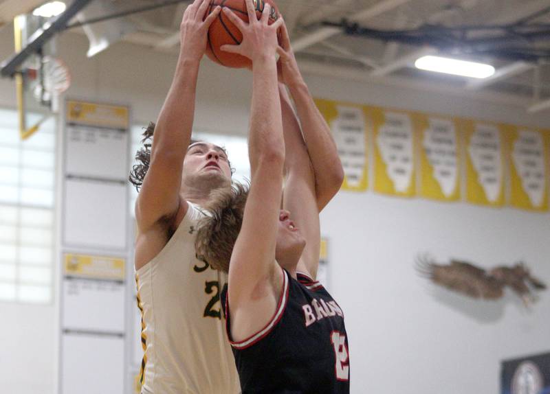 Crystal Lake South’s Michael Prokos, back battles  Barrington’s Alec Schmidts for a rebound in Hinkle Holiday Classic boys basketball tournament game action at Jacobs High School Tuesday.