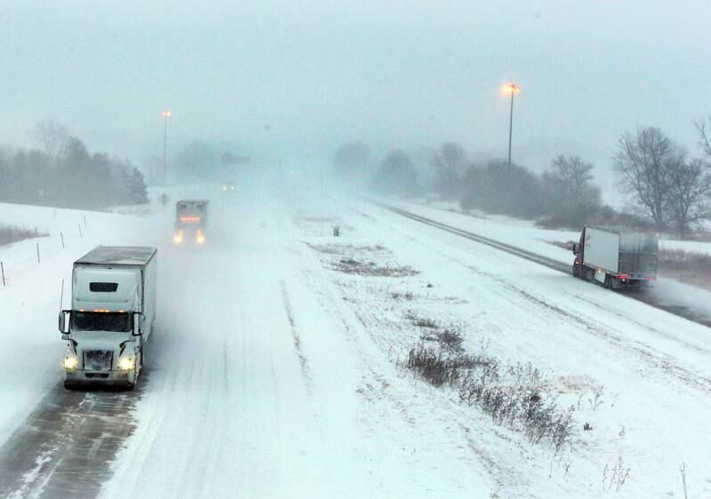 Semis drive slowly along Interstate 80 near the Interstate 180 interchange in Bureau County on Wednesday, Feb. 2, 2022, between Spring Valley and Princeton. Roads are snow covered as several inches are forecasted to fall across Starved Rock Country. Snow will taper off leaving to colder temperatures before warming up above freezing next week.