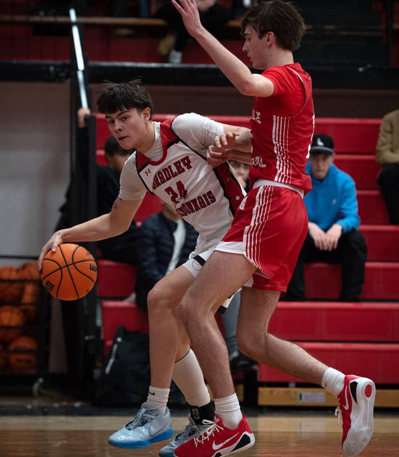 Bradley-Bourbonnais's Antonio Potoski, left, controls the ball as Naperville Central's Nathan Abrahamson guards in a game on Monday, December 15, 2025.