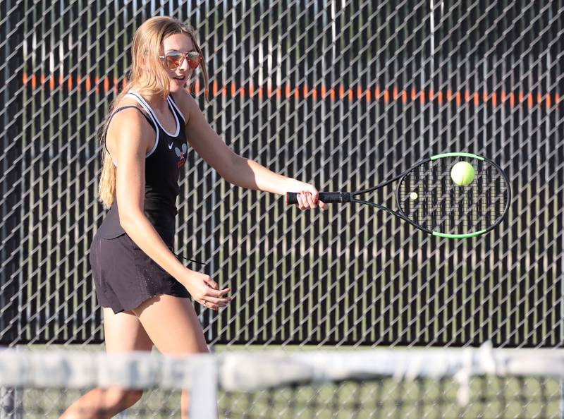 DeKalb number one doubles player Alissa Kocjan returns a serve during her match against Sycamore Wednesday, Sept. 13, 2023, at DeKalb High School.
