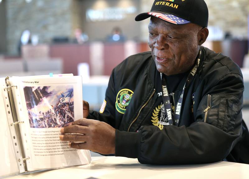 Daniel "Doc" Habeel, a U.S. Army veteran from DeKalb, flips through a book Tuesday, Sept. 19, 2023, at the Northwestern Medicine Kishwaukee Health & Wellness Center in DeKalb, that he put together that highlights Black veterans and activists who made significant contributions to the country. Habeel along with his late wife, Arnetha Gholston-Habeel, opened a veterans center in Chicago that has since closed.