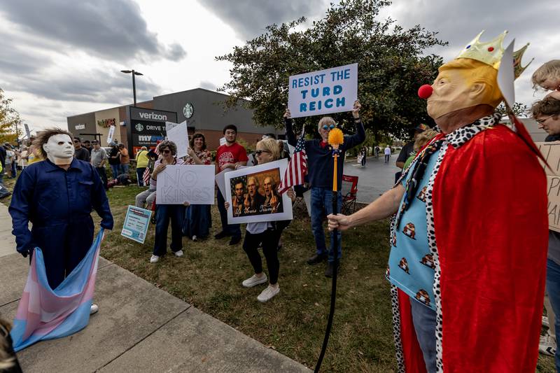 Someone in a Michael Myers costume stops to stare at someone in what was labeled a “King Cofeve” costume during the No Kings Protest in Joliet on Oct. 18, 2025.