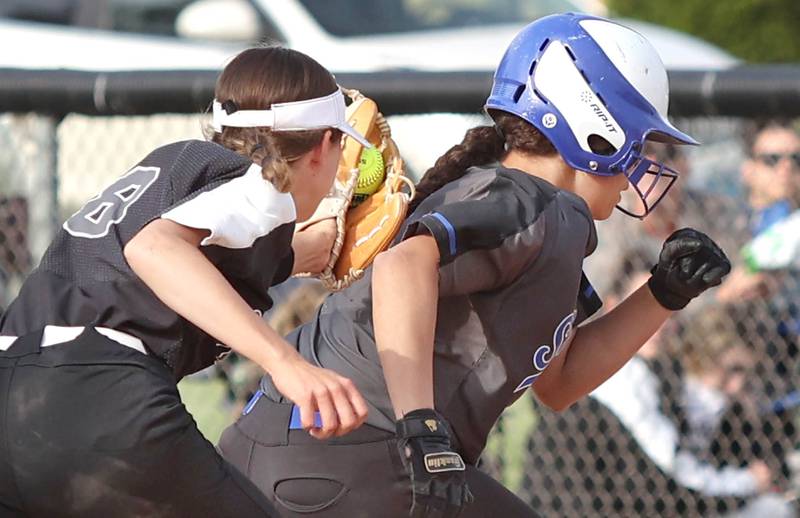 Kaneland's Gabriella Gonzales tags Woodstock's Jade Sanders during a rundown in their Class 3A Regional game against Kaneland Tuesday, May 24, 2022, at Kaneland High School in Maple Park.