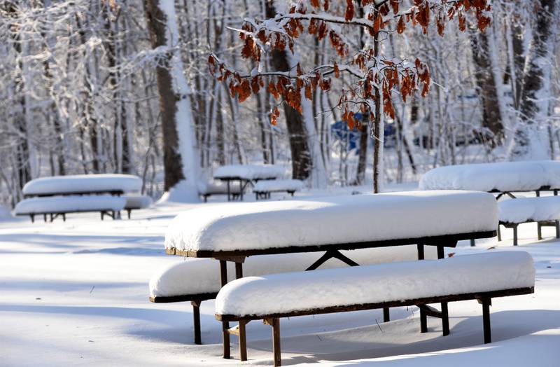 Snow covers picnic tables at Lowden State Park on Sunday, Jan. 14, 2024. Frigid weather followed a winter storm on Friday that deposited 10-12 inches across the region.