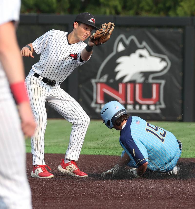 Marquette's Alec Novotney slides in with a stolen base as Fulton's Braeden Brennan takes the throw Monday, June 2, 2025, during their Class 1A supersectional game at Northern Illinois University in DeKalb.