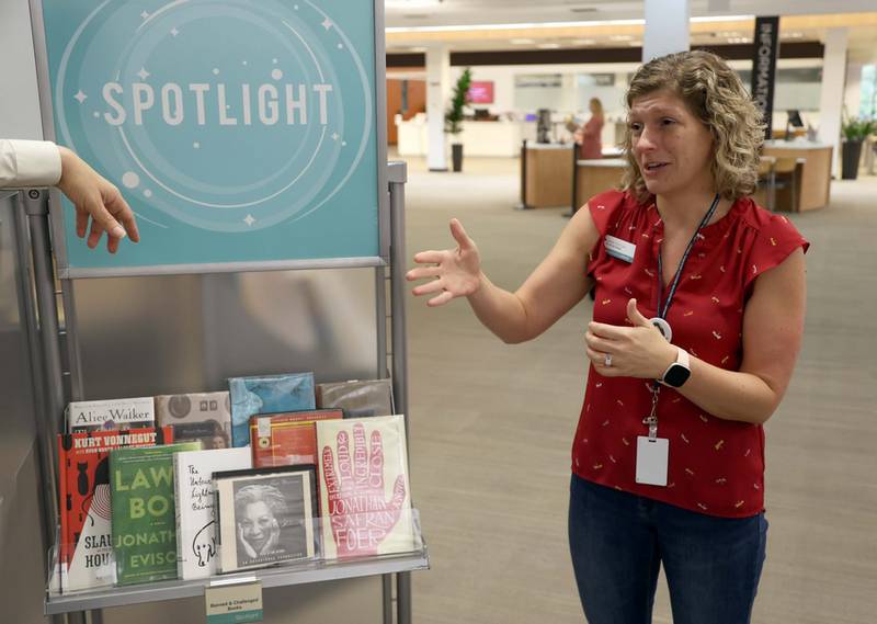 Jolie Duncan, info services manager at the Arlington Heights Memorial Library, stands in front of a display highlighting banned and challenged books. Libraries across the country marked Banned Book Week this month.
